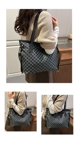 Detail of large tote bag with letter M pattern and premium black leather straps