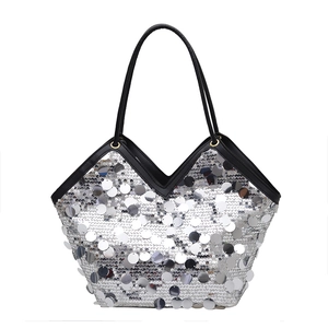 Chic silver sequin tote bag with a V-shaped top and sleek black handles for evening parties