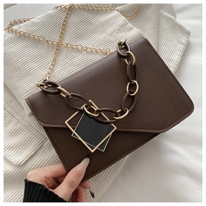 Close-up of brown PU leather shoulder bag featuring gold chain and square buckle