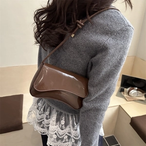 Brown patent leather shoulder bag with a high-gloss finish and modern minimalist design