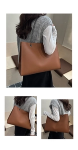 Détail d'un cabas en cuir marron montrant la texture grainée et la bandoulière chaîne