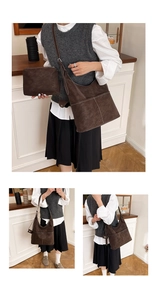 Detail of vintage brown suede hobo bag with white stitching and matching pouch bag