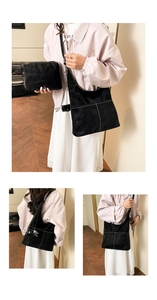 Detail view of retro black suede tote bag and matching pouch with contrast white stitching