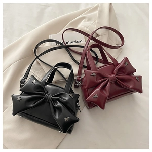 Detail of vintage bow crossbody bags with star studs in black and burgundy colors