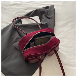 Detail of burgundy large capacity hobo bag with retro double pockets and silver metal buckles