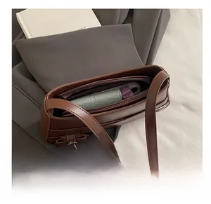 Interior view of brown leather bag showing spacious capacity and inner zipper pocket