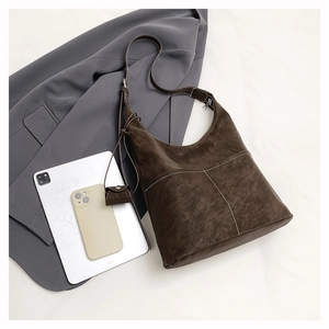 Deep brown suede tote bag detail with white contrast stitching and outer pockets