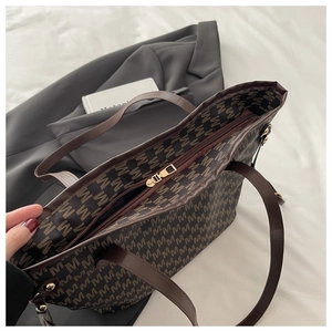 Macro view showing the smooth zipper closure and spacious interior of the brown tote bag