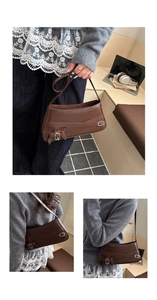 Detail view of brown shoulder bag with cross strap buckle and matte finish texture