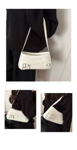 White leather underarm bag with decorative straps and silver buckle shown from multiple angles