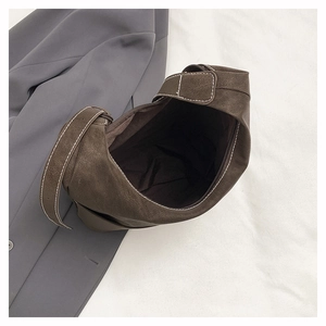 Detail of dark brown tote bag with white contrast stitching and spacious interior
