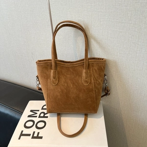 Brown suede bucket bag with top handles and detachable shoulder strap for daily commute