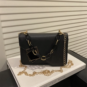 Chic black crossbody bag with gold chain strap and geometric hardware detail