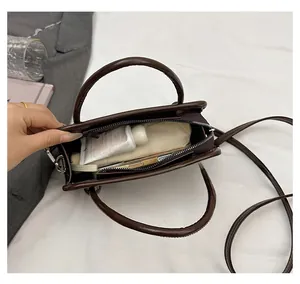 Top view of dark brown PU leather crossbody bag interior showing spacious daily storage capacity