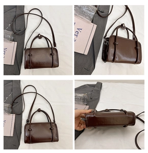 Detail view of mini dark brown PU leather handbag with dual handles and fashion embossing