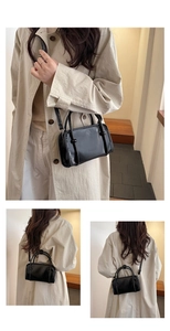 Detail of black leather crossbody bag with FASHION embossed logo and knotted handle design