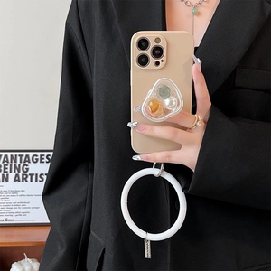 Beige iPhone case with floral pearl bracket and white silicone wrist ring lanyard detail