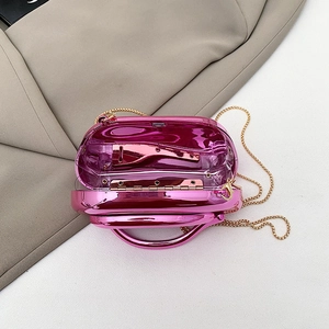Detailed interior of bright pink metallic mirror clutch with gold chain strap