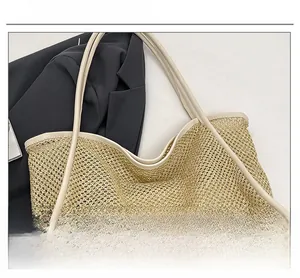 Detail of hollow mesh woven tote bag with smooth trimming on white background