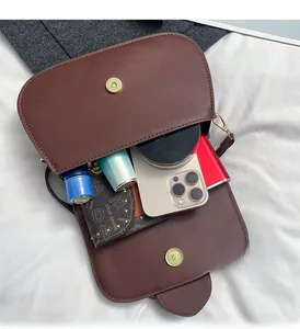 Macro shot of the spacious inner compartment of the brown retro flap crossbody bag