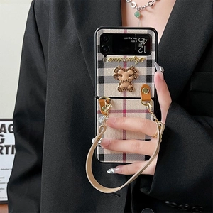 Detail of checkered foldable phone case for Samsung Z Flip with pearl bear chain strap