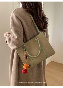 Detail of retro green checkered tote bag with colorful plush charms and long shoulder strap