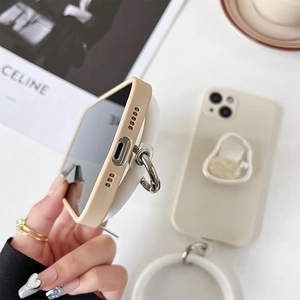 Close-up of beige iPhone case with circular ring holder and precise bottom cutouts