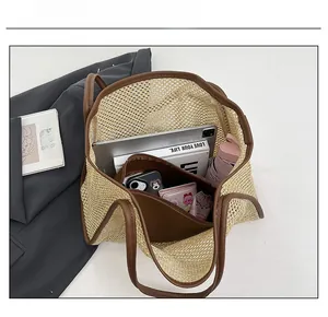 Capacity view of woven tote bag with leather straps holding a tablet, book, and umbrella