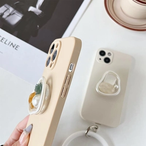 Close-up of iPhone case featuring large pearls, floral charms and a flexible air stent