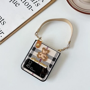 Z Flip phone case featuring black and white plaid pattern with 3D bear and leather strap
