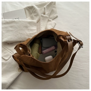 Top view of a large brown hobo bag showing spacious interior with daily essentials and strap