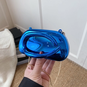 Detail showing the electric blue mirror finish and gold chain on this sleek clutch bag