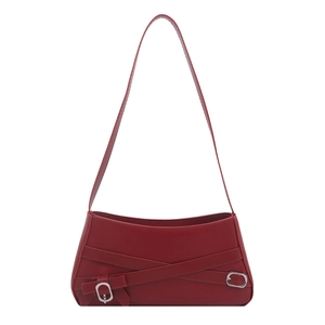 Retro burgundy shoulder bag with decorative belt straps and silver buckles on white background