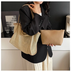 Detail of woven straw tote bag with matching leather pouch and sturdy shoulder straps