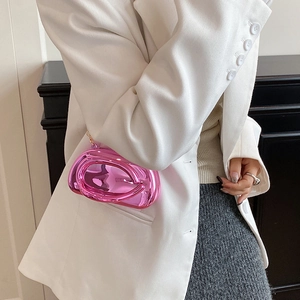 Detail of metallic hot pink clutch bag with mirror finish and gold chain shoulder strap