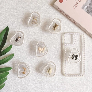 Detail of Korean style phone grip with 3D resin bear and pearl trim on clear case