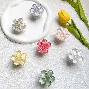 Detailed close-up of colorful flower-shaped resin phone grips with glitter finish