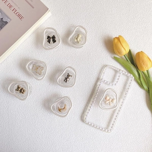 Chic Korean style phone griptok with pearl bow and bear designs on luxury background