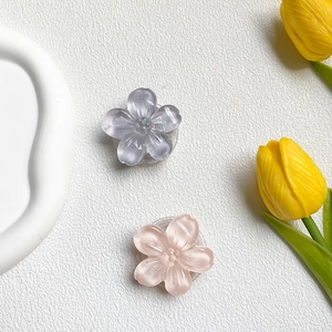 Macro shot of glittery semi-transparent resin flower grips in pink and purple colors