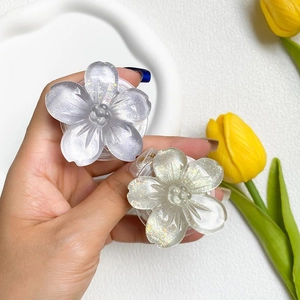 Detail of floral resin phone grips featuring glitter accents and translucent petals