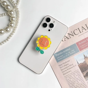 Chic sunflower phone grip with yellow petals and green leaves on a white smartphone