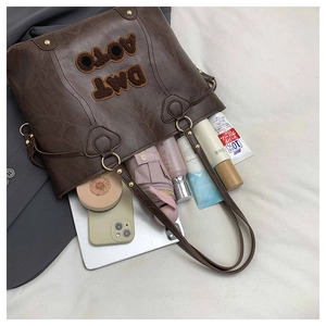 Large dark brown tote bag showing spacious interior for laptop and daily essentials