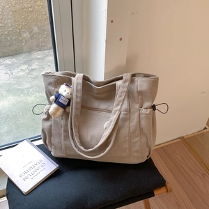 Minimalist beige corduroy tote bag with drawstring detail and cute bear charm
