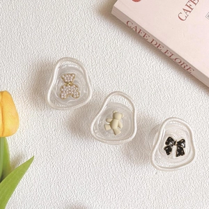 Three bear-themed phone grips with pearls and matte finish on aesthetic background