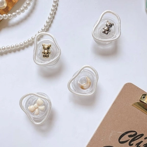 Close-up of stylish Korean ins style expandable phone grips with bear and bow charms