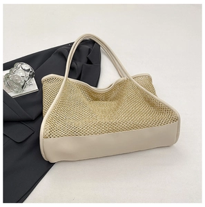 Macro detail of the woven mesh texture and creamy white PU leather strap on a tote bag
