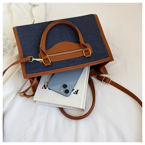Internal view of a denim tote bag showing its large capacity for books and phones
