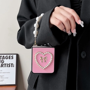 Pink leather Samsung Z Flip case with pearl heart, gold bow, and long pearl strap