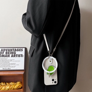 White silicone ring phone holder with crossbody lanyard shown in a lifestyle setting