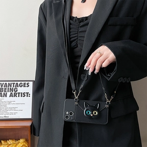 Crossbody iPhone case with black cat card holder and leather strap worn on a model